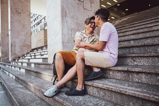 Gay couple sitting on the step