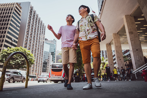Tourist gay couple walking visiting a city of São Paulo, Brazil