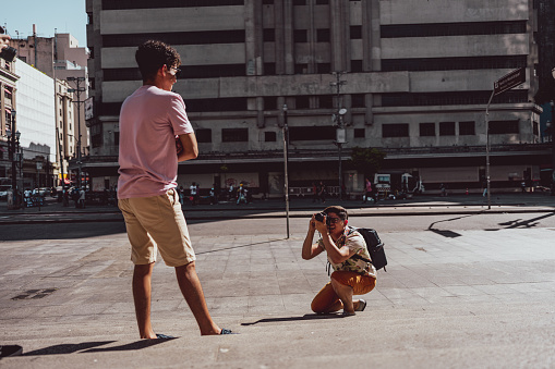 Gay man photographing his boyfriend in São Paulo city, Brazil