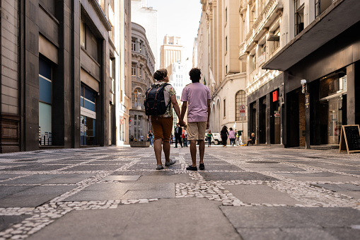 Tourist gay couple walking visiting the streets of São Paulo, Brazil