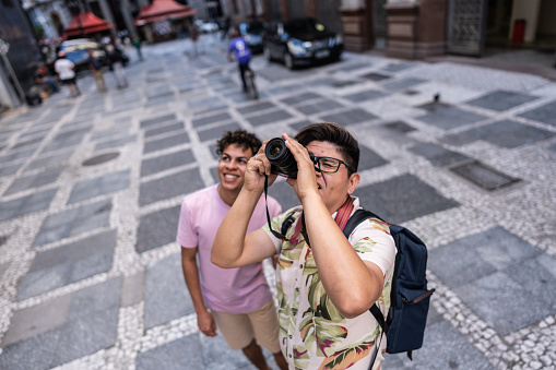 Tourist gay couple photographing city of São Paulo