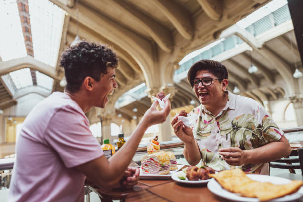 istock Gay couple talking and eating on a restaurant 1782602969