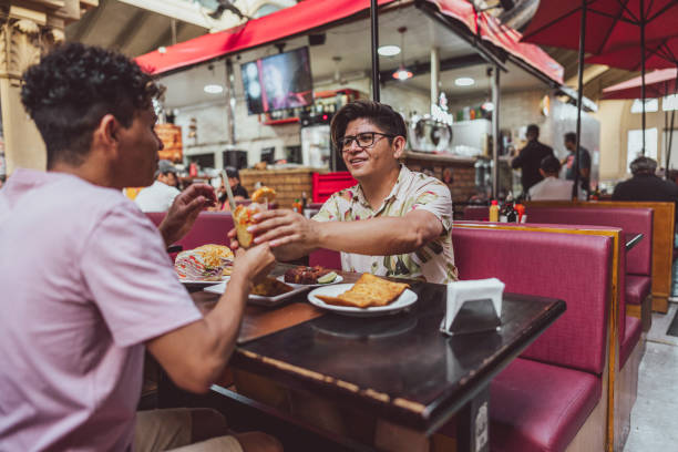 istock Gay couple talking and eating on a restaurant 1782602975
