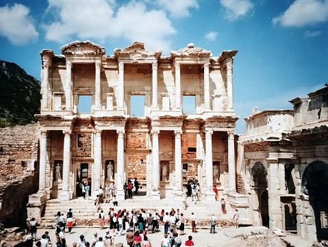 Ephesus. The Library of Celsus was built by Tiberius Julius Acquila to commemorate his father Tiberius Julius Celsus and was named after him.  Except being a library the building was also a mausoleum because the father was buried in a sarcophagus and placed under the floor. Over the centuries the building was damaged by multiple earth quakes and in the end only the facade survived. In its time it was one of the most beautiful buildings in the historic city of Ephesus.