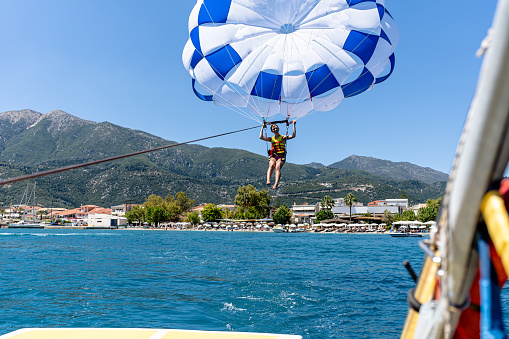 parasailing. ride on a colored parachute attached to a motor boat.