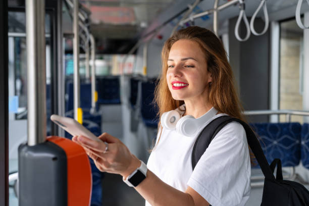 istock Young urban woman pays for a bus ticket using her mobile phone. Contactless mobile payment technology. 1782656521
