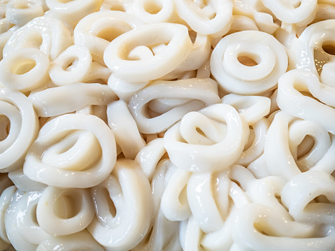 Fresh uncooked squid rings in grocery