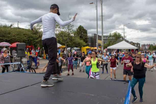 People dancing in the street directed by a choreographer in a outdoor activity in Bogota on november 5/2023