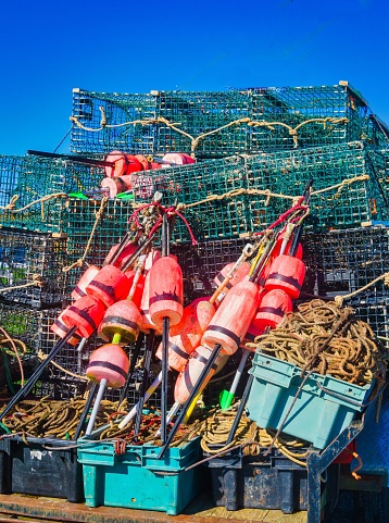 Stacks of lobster traps, ropes and colorful buoys are piled on the back of an old pick up truck on Cape Cod.