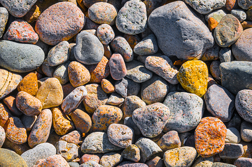 Smooth stones of various sizes, cfolors and textures on a Cape Cod beach.