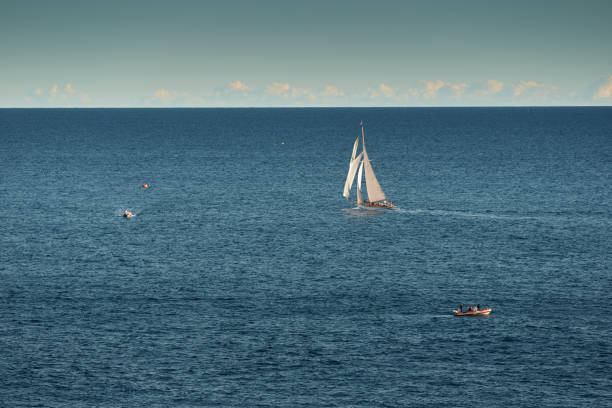 monaco, lonely vintage sail yacht in sea at sunset, huge sail boat, wealth life of billionaires - sailing light wind nautical vessel imagens e fotografias de stock