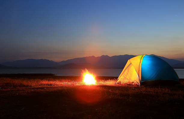 istock tent and campfire at sunset,beside the lake 178272106