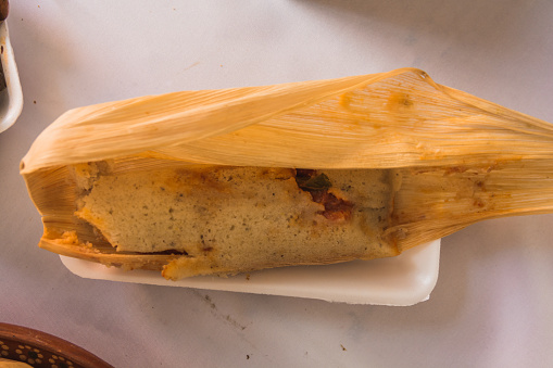 Tamales, typical Mexican food, of different flavors, wrapped in corn husks. Mole tamales.