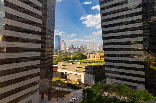 View of a tourist spot between two buildings, cable-stayed bridge in the background in the city of São Paulo, Brazil