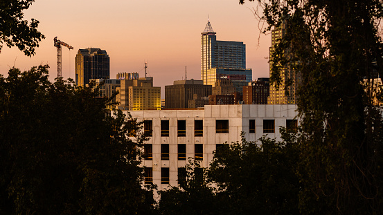 Raleigh, NC golden horizon: sunset bathes the construction site and Downtown skyline of Raleigh, North Carolina.