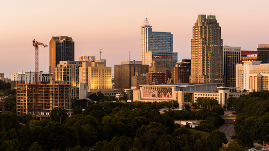 Golden sunset covers the construction site and Downtown skyline of Raleigh in North Carolina