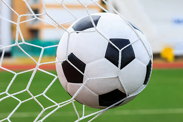 istock soccer ball in goal net 178274648