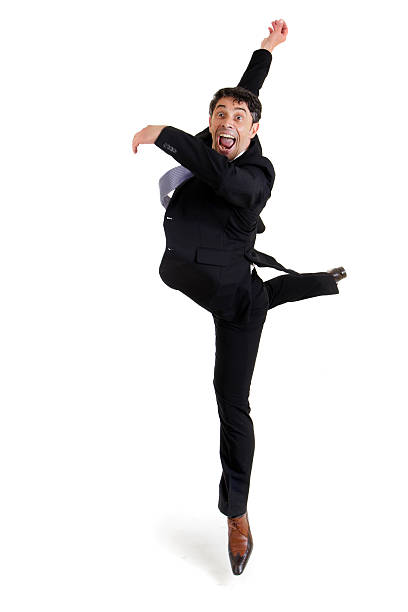 Agile businessman doing a pirouette stock photo