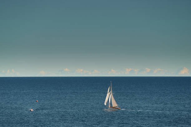 monaco, lonely vintage sail yacht in sea at sunset, huge sail boat, wealth life of billionaires - sailing light wind nautical vessel imagens e fotografias de stock