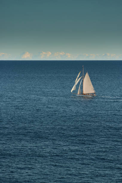 monaco, lonely vintage sail yacht in sea at sunset, huge sail boat, wealth life of billionaires - sailing light wind nautical vessel imagens e fotografias de stock