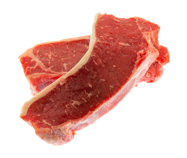 istock Side view of two New York strip steaks isolated on a white background. 1782777647