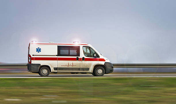 istock Ambulance driving down a road with sirens on 178277900