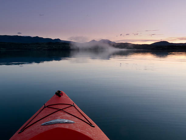 istock Paddling in a kayak through calm sunset waters 178279023