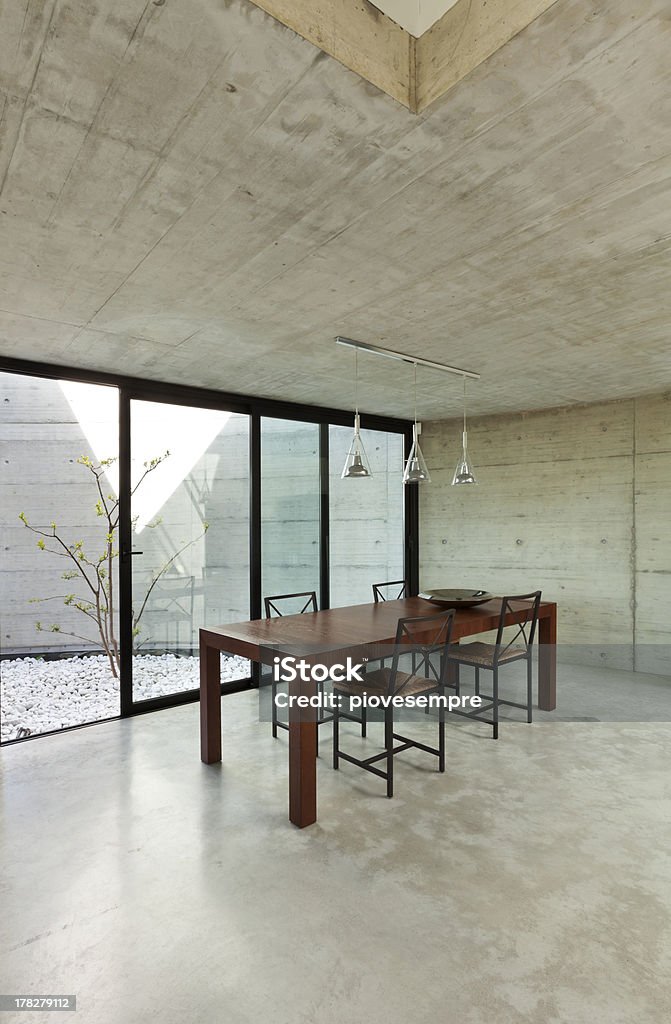 interior, wooden dining table "beautiful modern house in cement, interior, wooden dining table" Dining Table Stock Photo