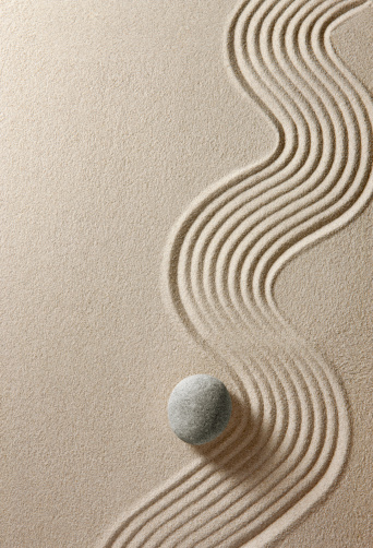 Stone on sand background