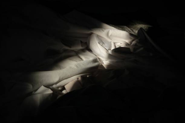 Shadow of a street lamp on white wall
