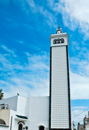 Abdulla Ali Yateem Mosque square minaret with four clocks and decorate with muqarnas in Manama Bahrain