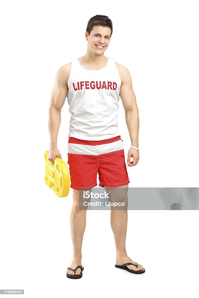 Smiling lifeguard on duty posing Full length portrait of a smiling lifeguard on duty posing isolated on white background Lifeguard Stock Photo