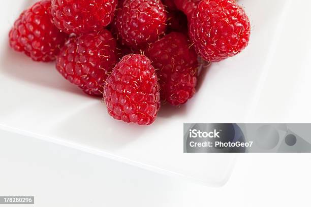 Raspberries In A White Plate Stock Photo - Download Image Now - Berry Fruit, Brambleberry, Food and Drink