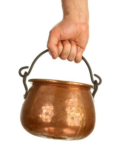 Hand holding bronze pot stock photo