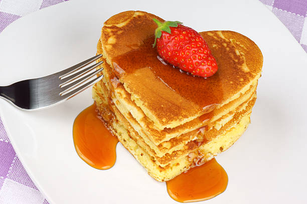 istock Heart-shaped pancakes with syrup and strawberry 178280885