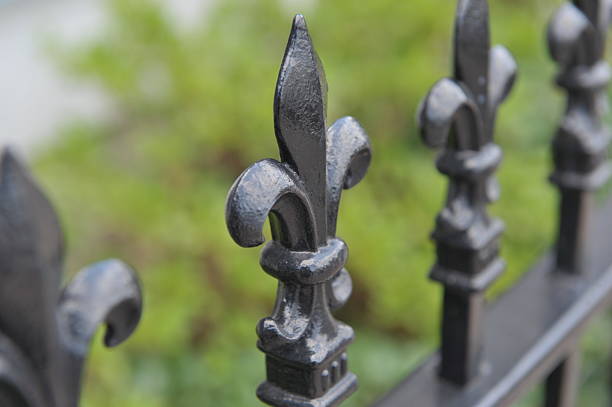 Top of the Fence Top of the wrought iron fence in New Orleans. new orleans fleur de lis stock pictures, royalty-free photos & images