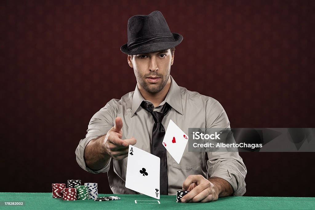 Poker Player Poker player, on a red background, throwing poker chips. Ace Stock Photo