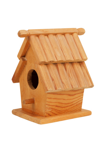 Small wooden birdhouse on a white background