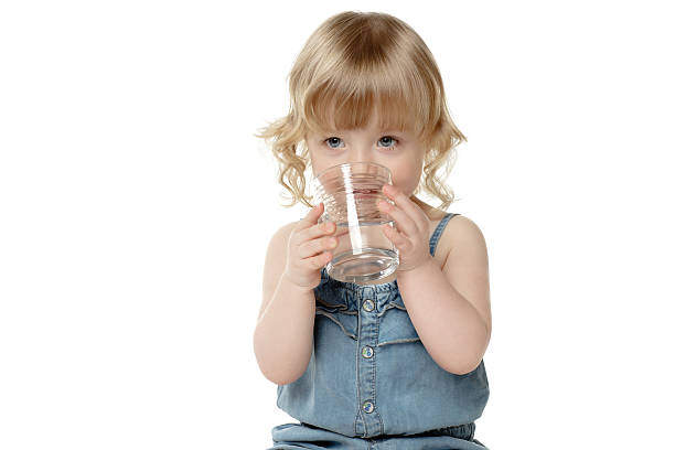 Adorable little girl drinking water
