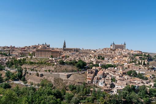 Toledo cityscape with Alcantara bridge (Puente de Alcantara) over Targus river. Spain