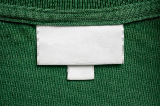 istock Blank white laundry care clothes label on green shirt fabric texture background 1782846564