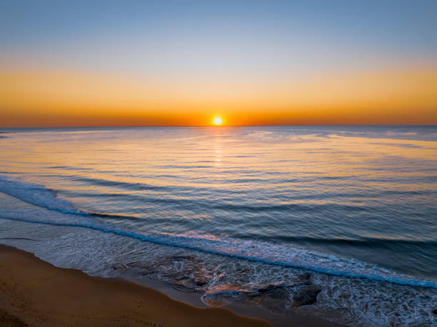 istock Aerial sunrise seascape with a hazy sky from fire reduction burnoffs 1782912820