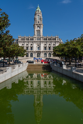 People are visiting the town square. Porto City Hall (Pacos do Concelho) and City Sign - Porto, Portugal.