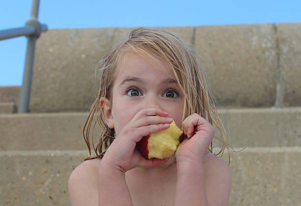 istock Young girl eating an apple 178292104