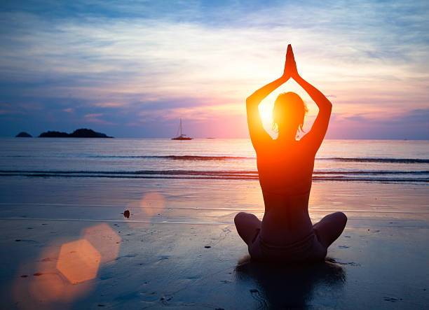 istock Silhouette young woman practicing yoga 178292107