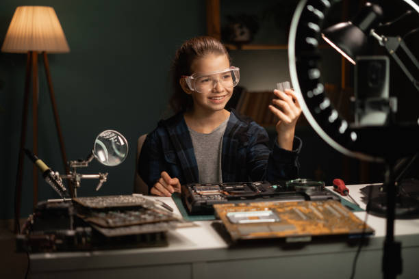 Digital World with DIY Magic. Young blogger wields her smartphone and ring light to share her tech repair expertise, inspiring a new generation of electronics enthusiasts one video at a time.