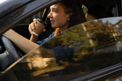 Close-up portrait busy successful business lady riding car office drinking coffee good morning traffic jam. Copy space