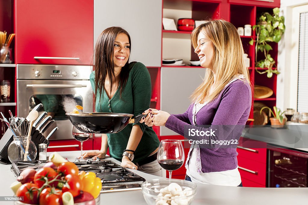 Young women in the kitchen Young women preparing meal in the kitchen 20-29 Years Stock Photo