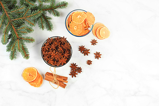 Christmas composition with traditional winter spices to boost immunity during the cold period. Star anise, cinnamon, dried oranges and tangerines with spruce branches. New Year's Eve and Christmas concept, selective focus