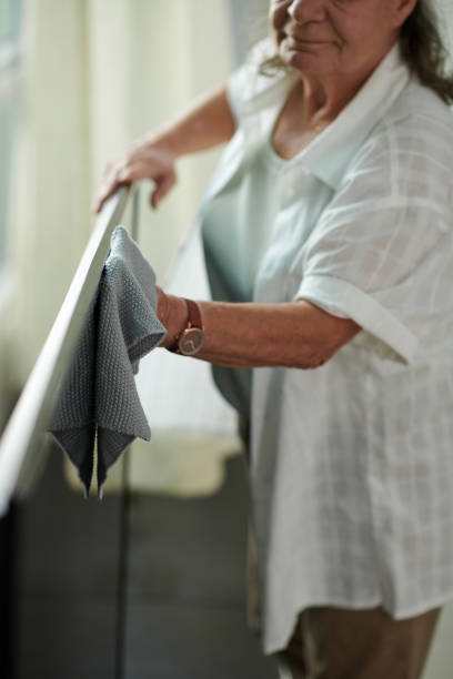 istock Elderly Woman Wiping TV Set 1782963773